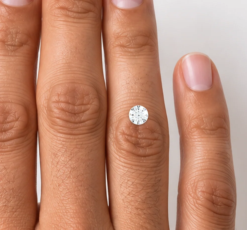 A 1 carat round diamond shown actual size on a hand