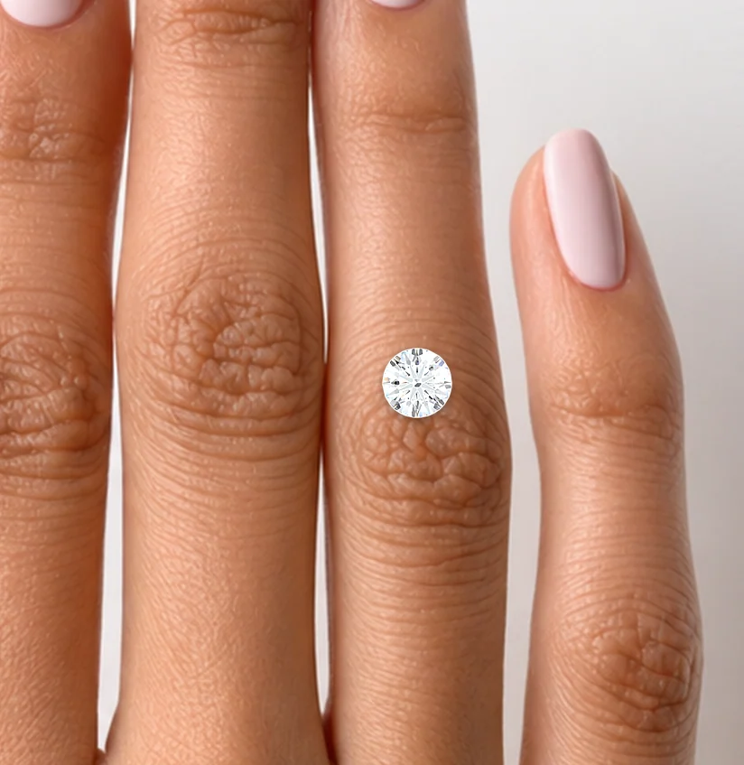 A 1 carat round diamond shown actual size on a hand
